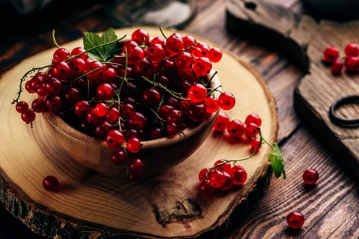 Fresh picked red currants in wooden bowl