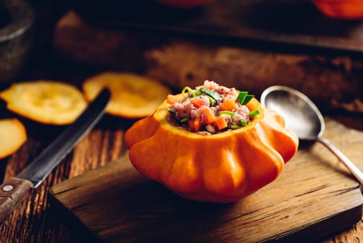 Yellow pattypan squash stuffed with minced meat, carrot and leek on cutting board