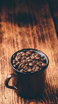 Brown mug full of roasted coffee beans