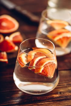 Water infused with red oranges in glass