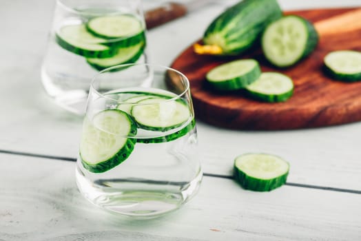 Water infused with sliced cucumber in a drinking glass