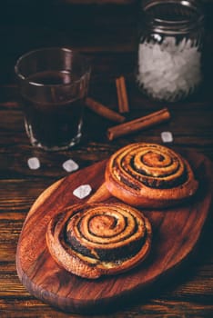 Sweet roll with poppy seeds and glass of espresso