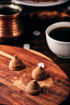 Homemade chocolate truffles coated with black coffee