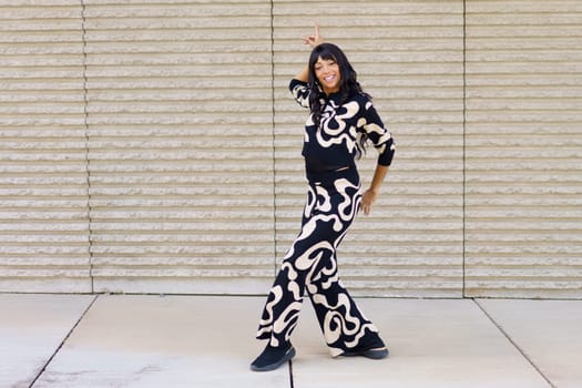 Full length photo of a happy beauty caucasian female confident modern freestyle dancer acting in the street