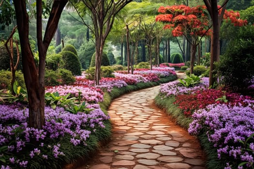 A path through a garden with a stone walkway and orange flowers. The flowers are in full bloom and the path is lined with green plants