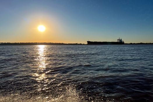 The sun falling on the banks of the Rio Parana, Rosario, Argentina. Horizontal photo.wallpaper.