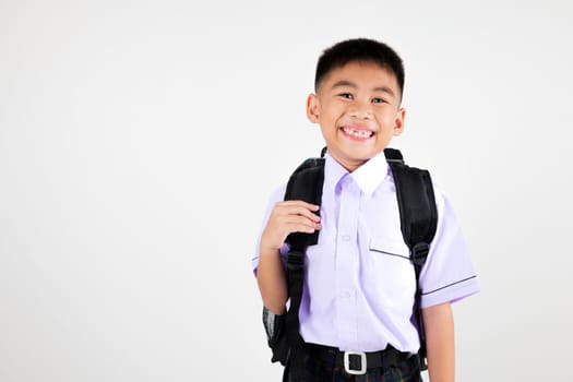 Portrait smile Asian little boy primary posing with schoolbag phone studio shot isolated white background, happy cute man kid wear school uniform and backpack learn new things, back to school concept