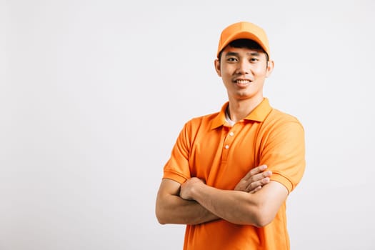 Portrait professional attractive delivery happy Asian man standing he smile wearing orange t-shirt and cap uniform crossed arms looking to camera, studio shot isolated on white background