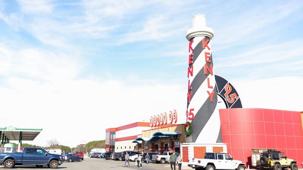 Striped Lighthouse Sign and Building Kenly 95 Truckstop with Blue Sky and White Clouds - Kenly, NC USA 03.15.2024.
