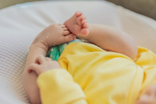The newborn's skin is peeling. Mom uses skin products and massages to care for and soothe the baby's delicate skin, ensuring comfort and promoting healthy skin.