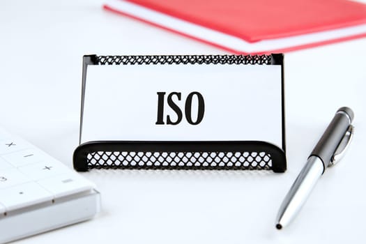 Business and ISO concept. ISO standards quality control symbol. Concept word ISO on a business card on a white background