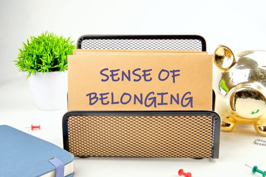 SENSE OF BELONGING written on a postal envelope in a stand on a white background