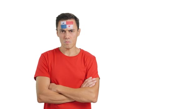 Dignified and serious man with panamanian flag painted on face looking the camera with dignity