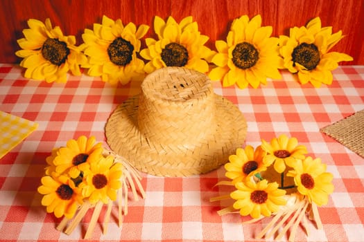 Decorative background for the Brazilian holiday Festa Junina. With sunflowers and straw hats.