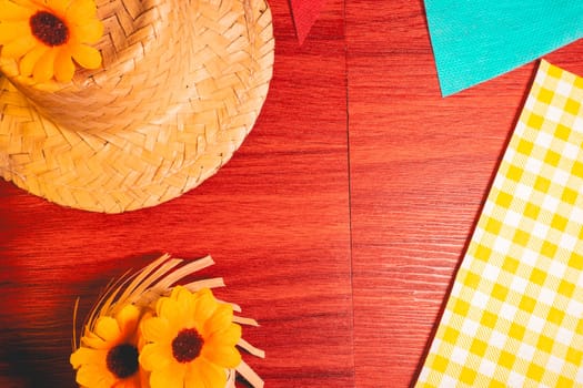 Decorative background for the Brazilian holiday Festa Junina. With sunflowers and straw hats.