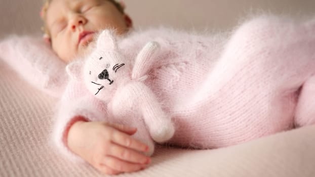 Cute Newborn Baby Asleep Hugging A Toy