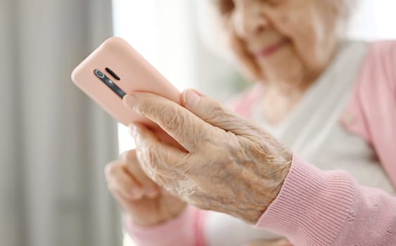 Elderly Woman Using Smartphone Reading Internet News, Close Up View
