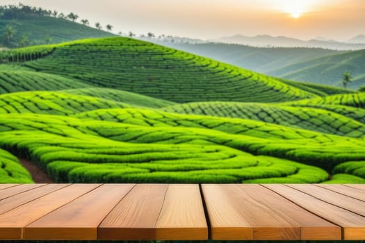The empty wooden table top with blur background of tea plantation. Exuberant imag