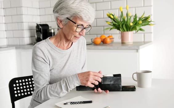Middle-Aged Woman's Hands Counting Euro Cash Notes In Her Wallet