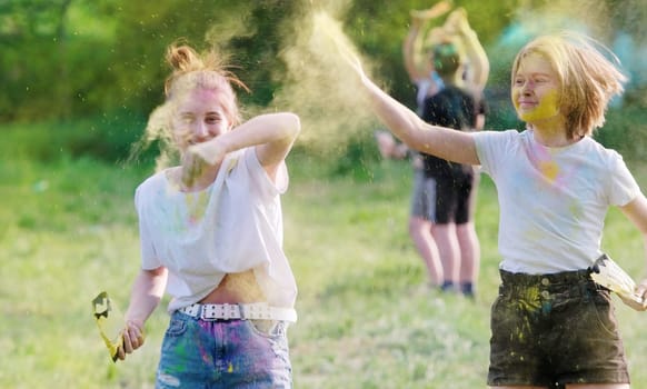 Sisters Tossing Dry Bright Paint On Holi Festival