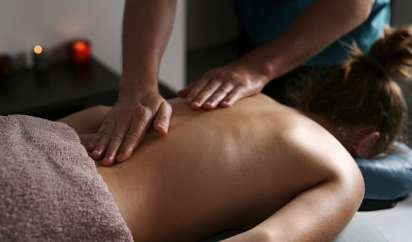 Relax Massage Procedures In A Spa Salon, Masseur Doing Healthy Back Massage For Young Girl