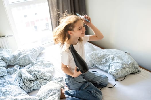 Cute Little Girl Drying Hair With A Hairdryer In Sleeping Room