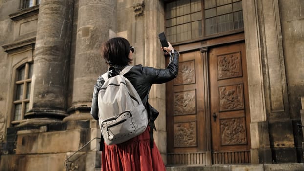 Attractive Female Tourist Walks With Germany Flag In Dresden'S Historical Center, Taking Pictures Of Sightseeing Spots