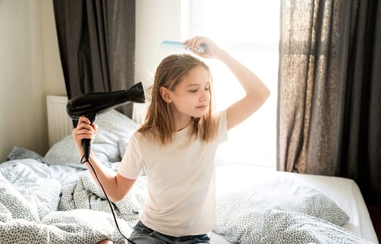 Cute Little Girl Drying Hair With A Hairdryer In Sleeping Room
