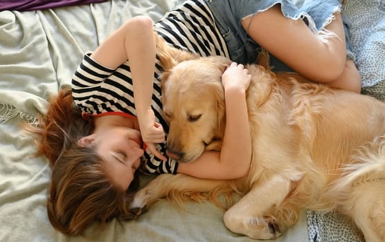 Cute Girl Playing With Golden Retriever Dog, Lying In Bed