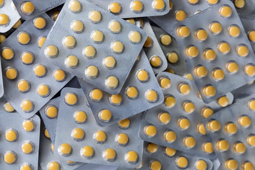 A lot of yellow pills packs. Pharmaceutical medicine pills. High quality photo