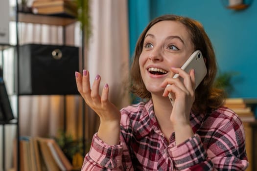 Excited businesswoman freelancer answering to client on mobile phone call using smartphone. Conversation. Caucasian woman girl working online remote distance job talking discussing at home office desk