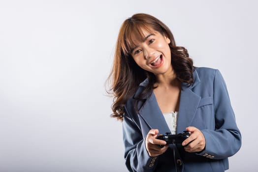 Asian happy portrait beautiful business woman wearing a suit smile lifestyle games technology her holding joystick game playing on hands on white background with copy space for text, Relaxation time