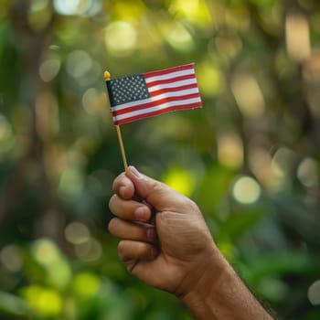 Focused image of a hand proudly holding a flag, of America is Independence Day