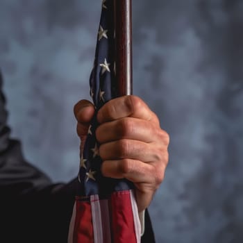 Focused image of a hand proudly holding a flag, of America is Independence Day