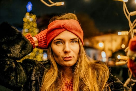 Winter fun on the street: Girl with sparklers, smiles in warm jacket and hat. Festive Christmas or New Year celebration,