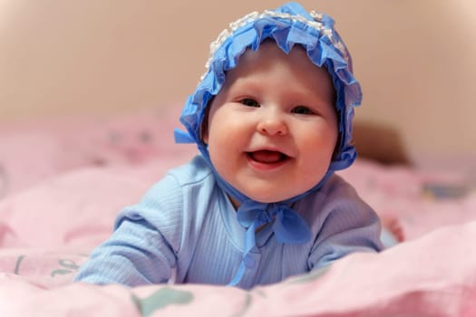 Dreamy Baby in Blue Bonnet on Pink Blanket. Selective focus