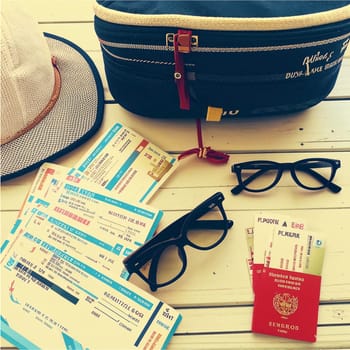 High quality photo. Hat and bag, with glasses and tickets.