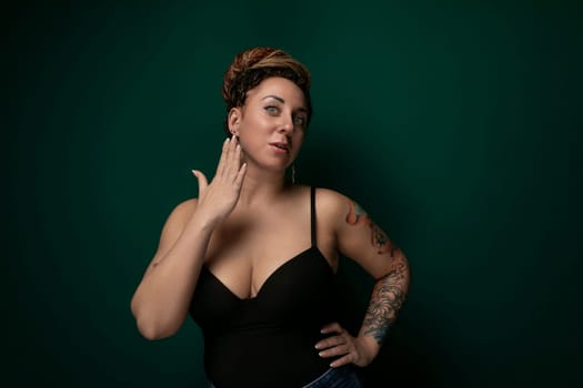 A woman dressed in a black top strikes a pose for a photograph, confidently showcasing her style and personality in front of the camera. She stands with poise and grace, capturing the attention of the viewer with her elegant presence.
