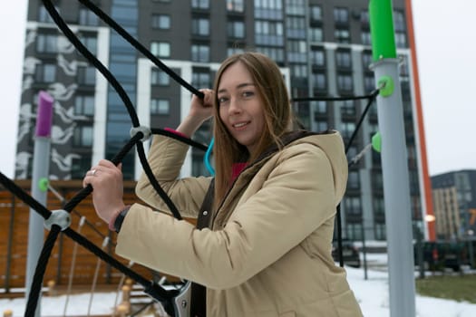 A woman is holding a large object in her hands, displaying strength and determination. The object appears heavy and requires effort to hold steady.