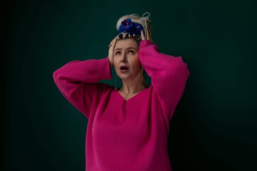 A woman is pictured wearing a crown on her head. She appears confident and regal, with a hint of elegance in her posture and expression. The crown is ornate and shines under the light.