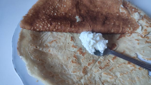 pancakes with sour cream food on a plate. High quality photo