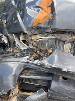 broken passenger car with rust close-up, standing outside, crumpled metal, broken headlight