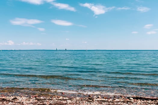 Blue sea and sailing boats on a sunny day. Beautiful seascape.