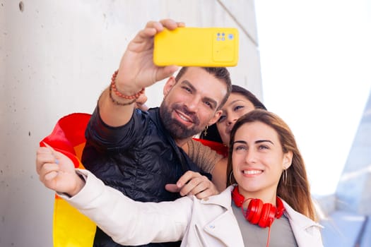 Happy multiethnic group of young gay friends take a selfie together on campus. Multiracial students meeting in the city, concepts of youth, people's lifestyle, diversity and pride.