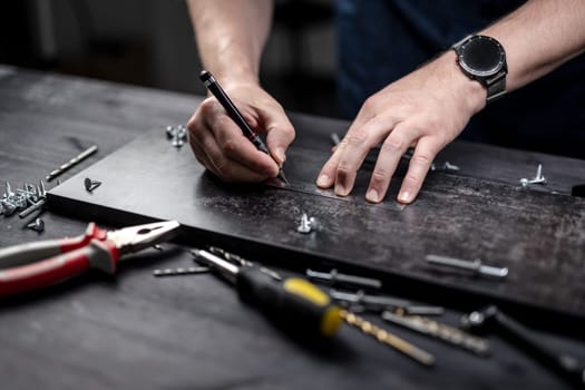 Man Measures Board With Ruler, Hands In Close-Up View