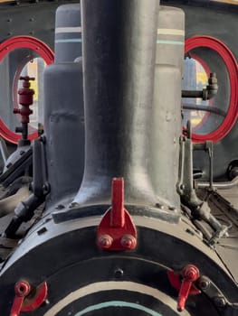 A close-up photo capturing the intricate details of a classic steam train's machinery.