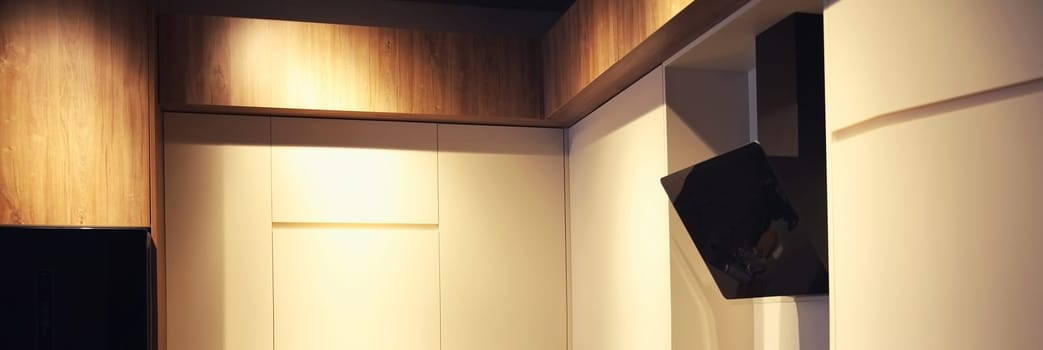 Stylish black flat kitchen hood with screen touch panel and designer lighting.