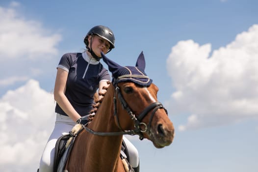 Portrait of a girl jockey riding a horse