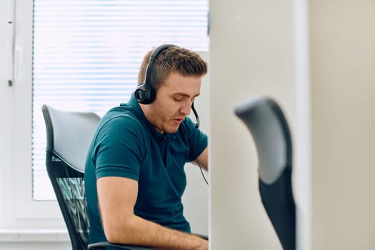 A detailed close-up captures a focused customer support representative wearing a headset while providing assistance in a call center setting.