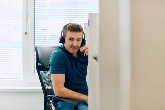 A detailed close-up captures a focused customer support representative wearing a headset while providing assistance in a call center setting.